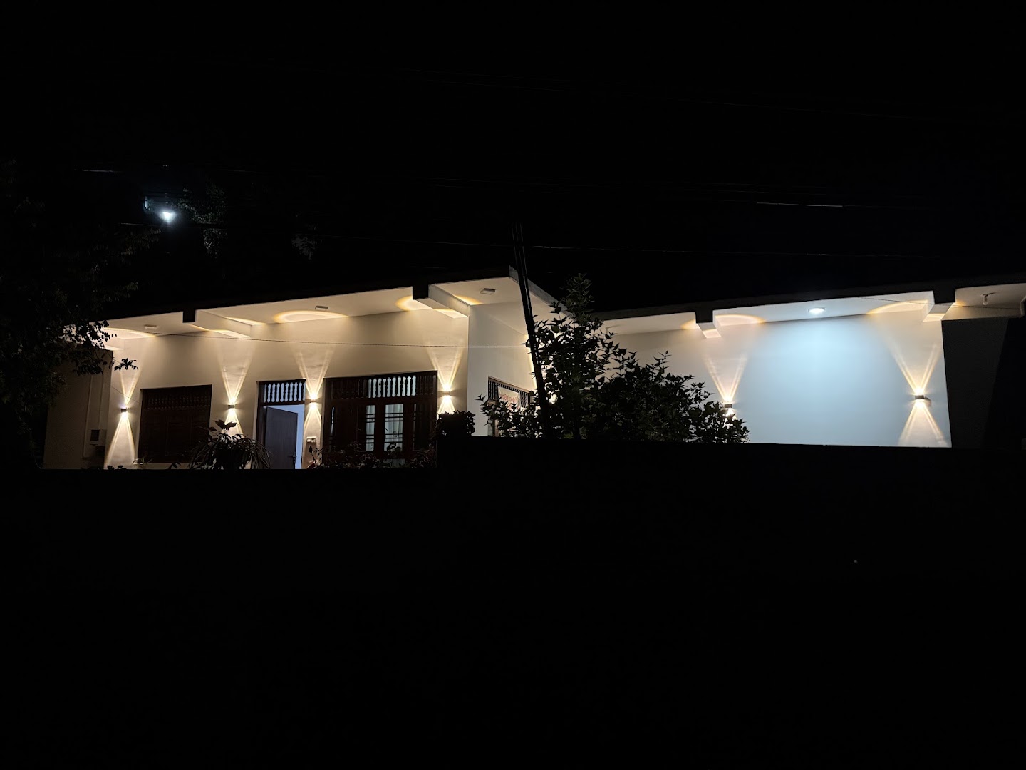 White villa exterior illuminated at night