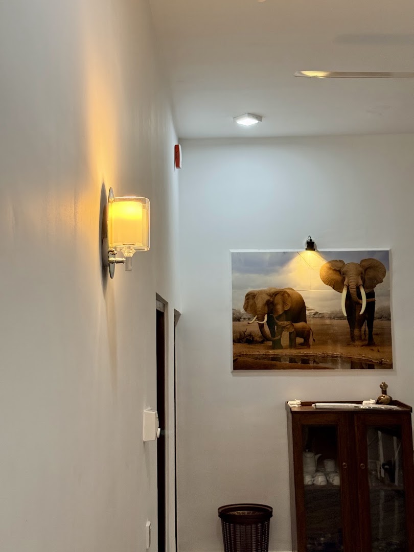 Villa hallway with warm wall light and elephant artwork
